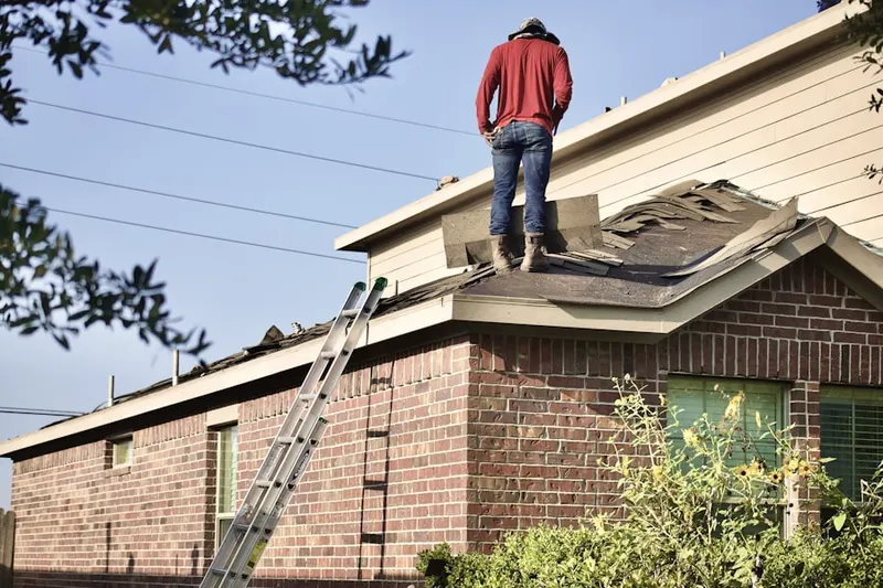 Professional roofer working on a residential roof in Micro